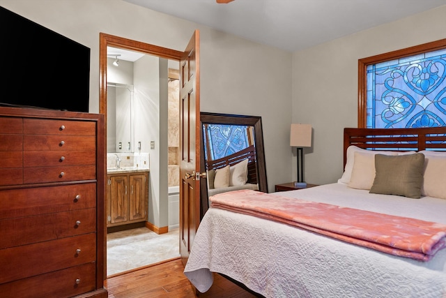 6500 Waconda Point Rd, Harrison, TN 37341 - bedroom with ensuite bath, a sink, and light wood-style flooring