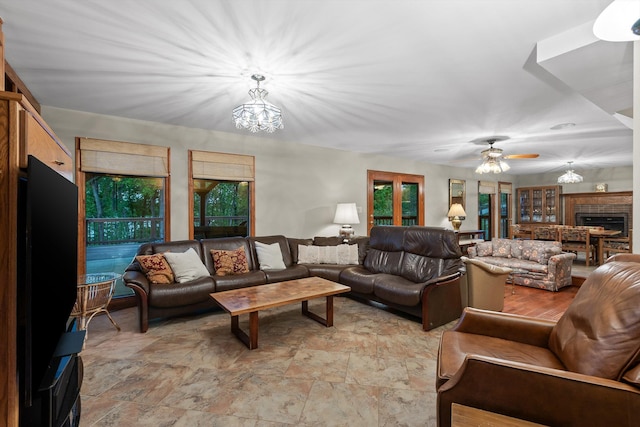 6500 Waconda Point Rd, Harrison, TN 37341 - living area featuring ceiling fan with notable chandelier and stone finish floor