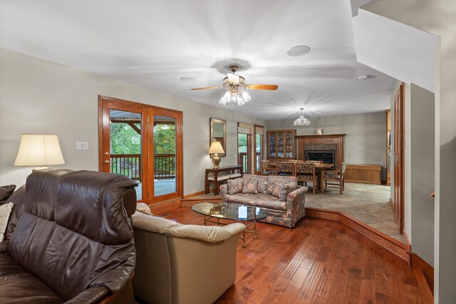 6500 Waconda Point Rd, Harrison, TN 37341 - living area featuring hardwood / wood-style floors, baseboards, a fireplace, and ceiling fan