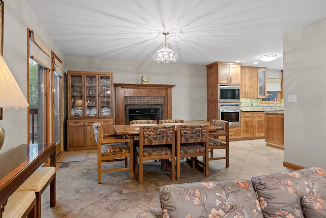 6500 Waconda Point Rd, Harrison, TN 37341 - dining room featuring a chandelier and a tile fireplace