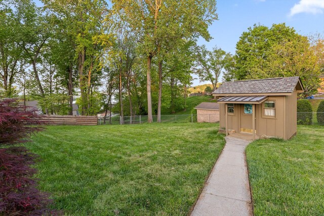 6500 Waconda Point Rd, Harrison, TN 37341 - view of yard featuring a fenced backyard, a storage unit, and an outdoor structure