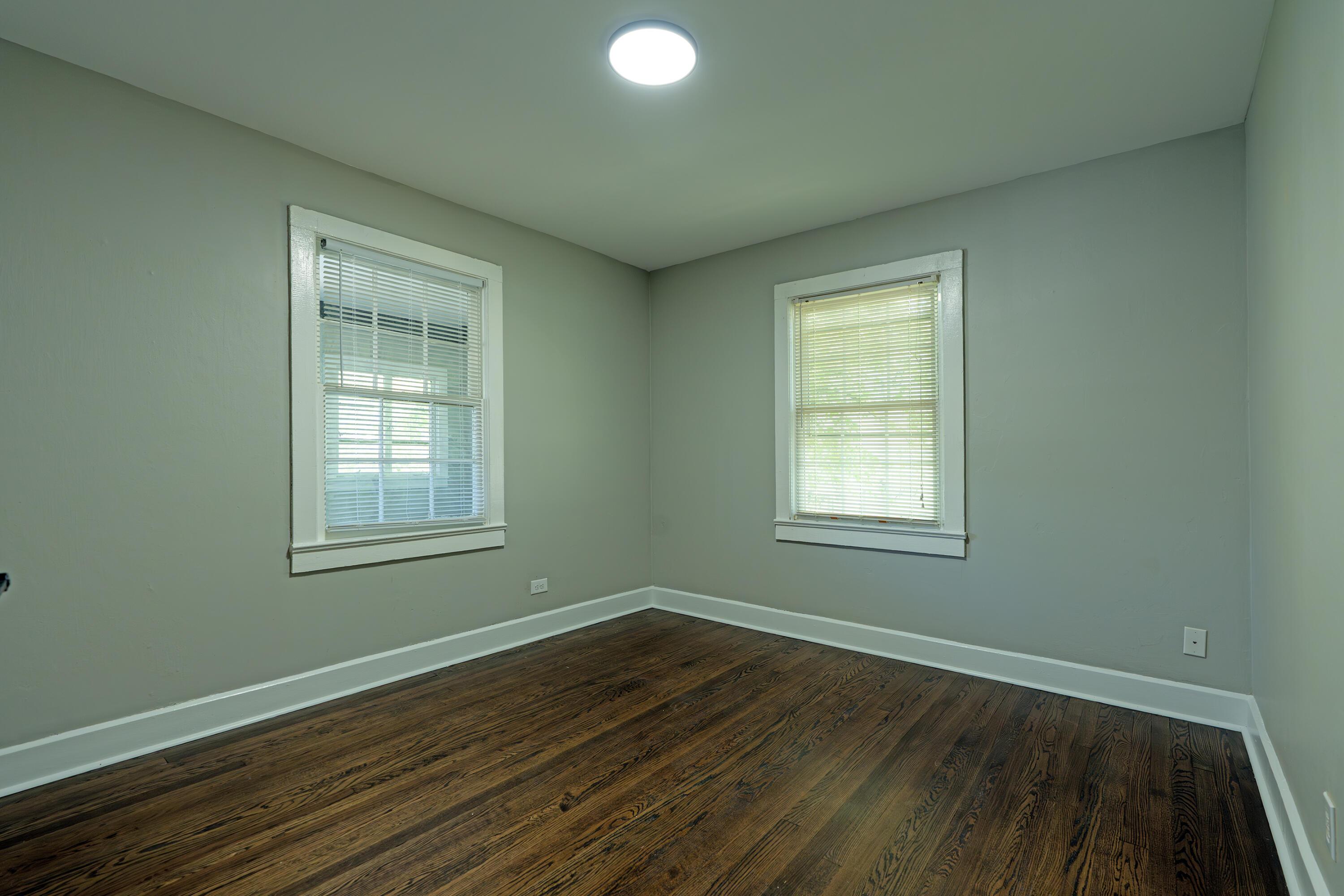 3 Whirlaway Dr, Chattanooga, TN 37421 - empty room featuring baseboards, dark wood-style floors, and a healthy amount of sunlight