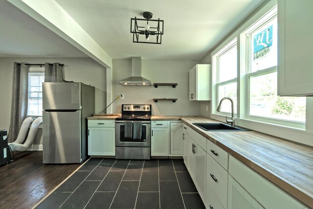 3 Whirlaway Dr, Chattanooga, TN 37421 - kitchen featuring plenty of natural light, butcher block counters, wall chimney exhaust hood, stainless steel appliances, and a sink