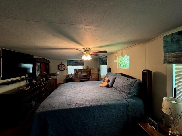 bedroom featuring a textured ceiling and a ceiling fan