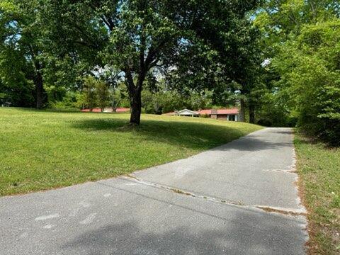 view of property's community with a yard and view of wooded area