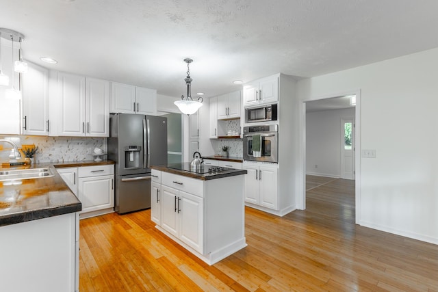 14 Hillcrest Ct, Ringgold, GA 30736 - kitchen with stainless steel appliances, a sink, dark countertops, tasteful backsplash, and white cabinets