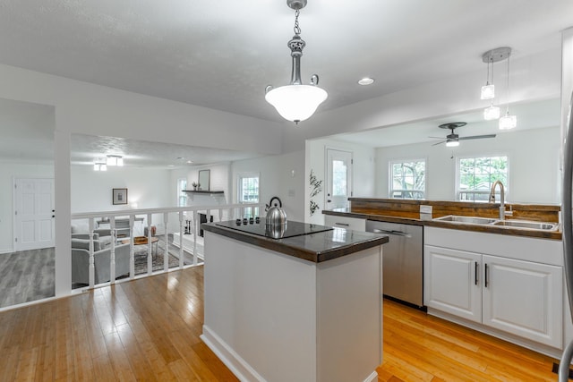 14 Hillcrest Ct, Ringgold, GA 30736 - kitchen featuring a sink, black electric stovetop, stainless steel dishwasher, dark countertops, and light wood-type flooring