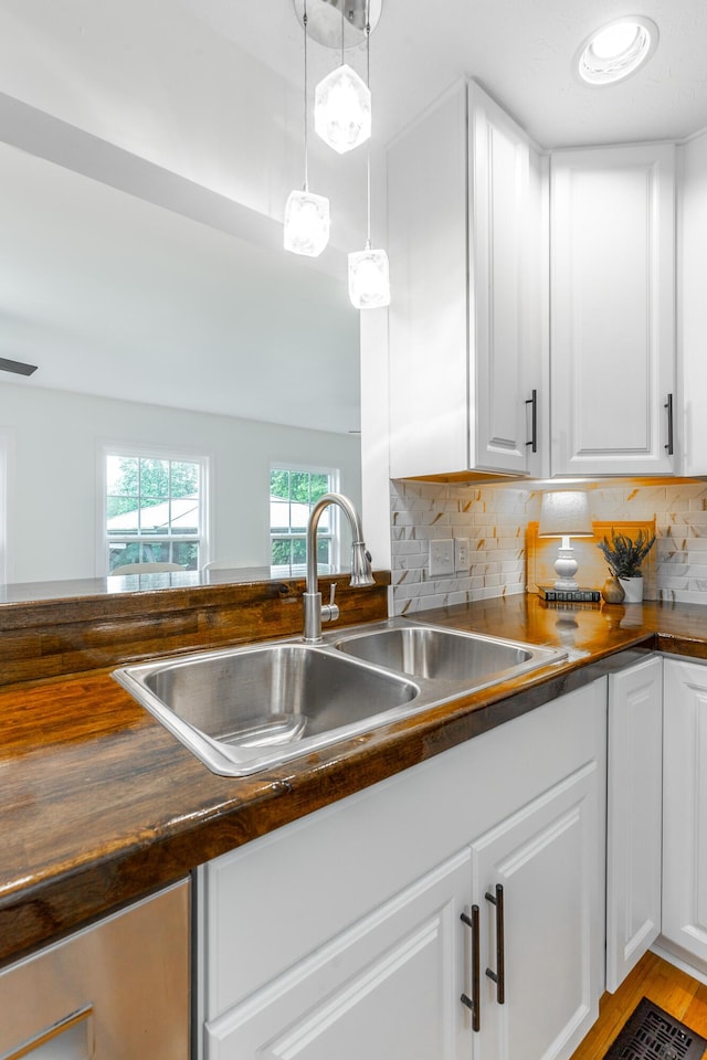 14 Hillcrest Ct, Ringgold, GA 30736 - kitchen with a sink, white cabinetry, tasteful backsplash, light wood finished floors, and hanging light fixtures