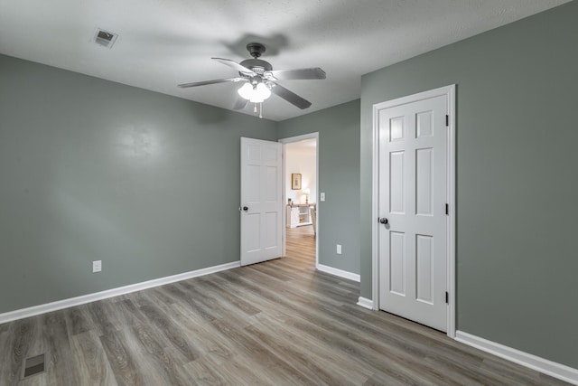 14 Hillcrest Ct, Ringgold, GA 30736 - unfurnished bedroom featuring wood finished floors, baseboards, and ceiling fan