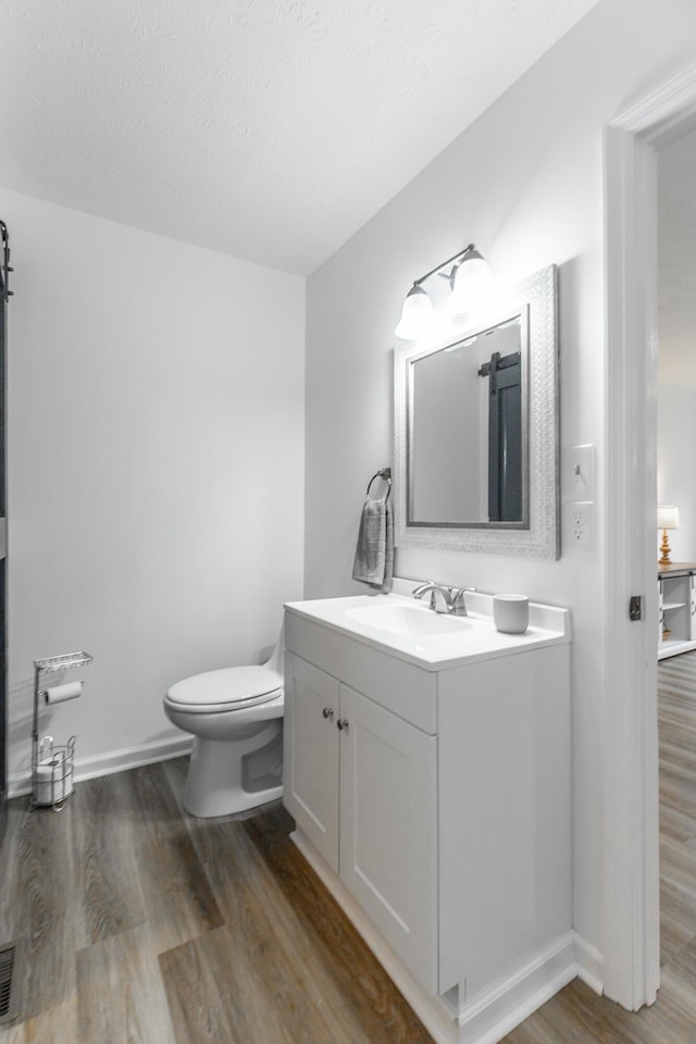 14 Hillcrest Ct, Ringgold, GA 30736 - bathroom with wood finished floors, vanity, toilet, and baseboards