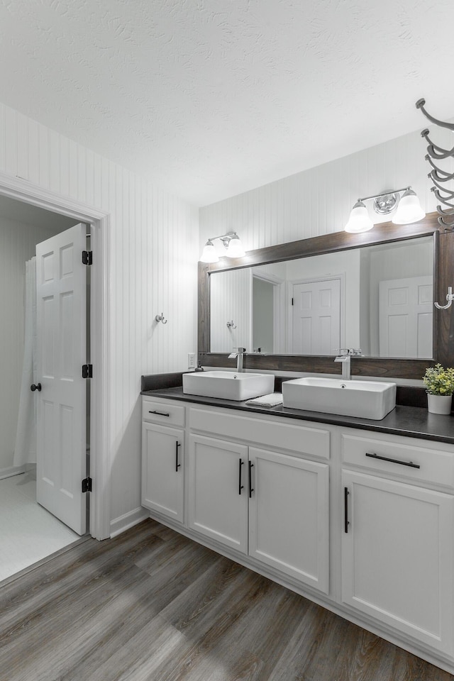 14 Hillcrest Ct, Ringgold, GA 30736 - bathroom with double vanity, wood finished floors, and a textured ceiling