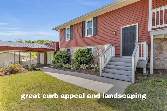 view of front facade featuring a front lawn, an outbuilding, stone siding, entry steps, and fence