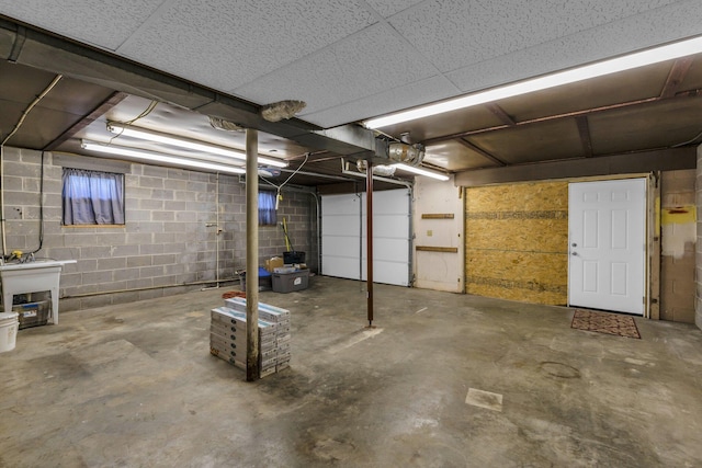 unfinished below grade area featuring concrete block wall