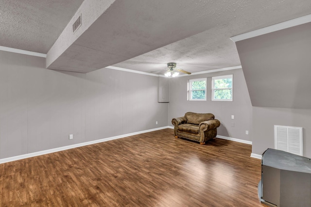 unfurnished room with ceiling fan, a textured ceiling, visible vents, and wood finished floors