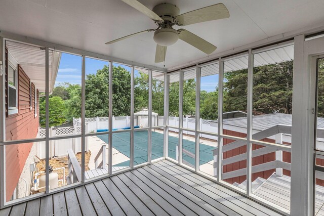 unfurnished sunroom with a ceiling fan