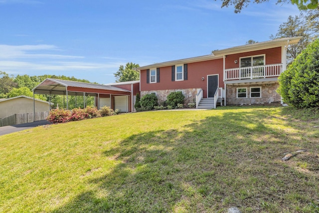 split foyer home with fence, a front yard, an attached garage, and stone siding