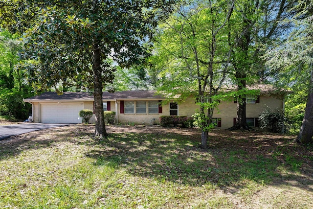 ranch-style home featuring brick siding, an attached garage, and driveway