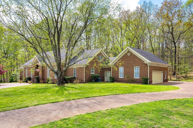 view of front facade with a garage, a front lawn, brick siding, driveway, and central AC unit