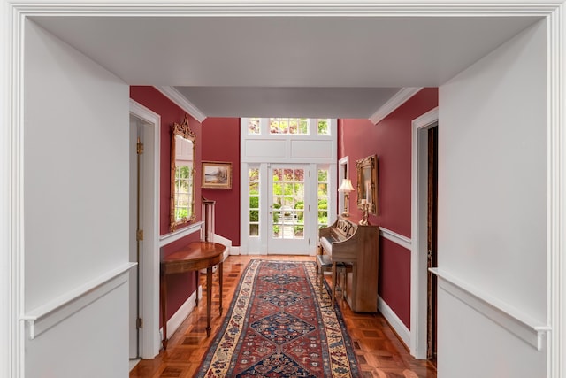 corridor with baseboards and crown molding