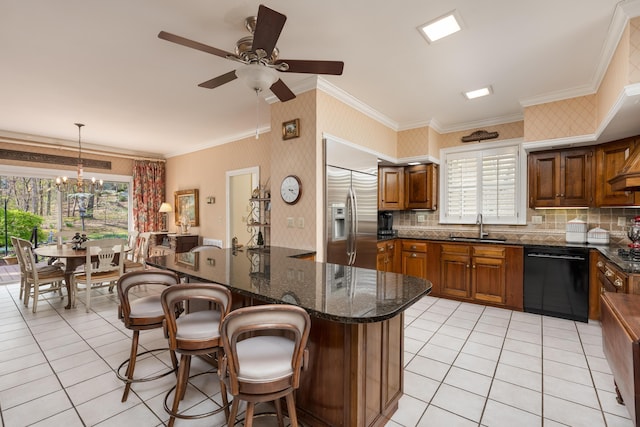 kitchen featuring light tile patterned flooring, dishwasher, a sink, and stainless steel built in refrigerator