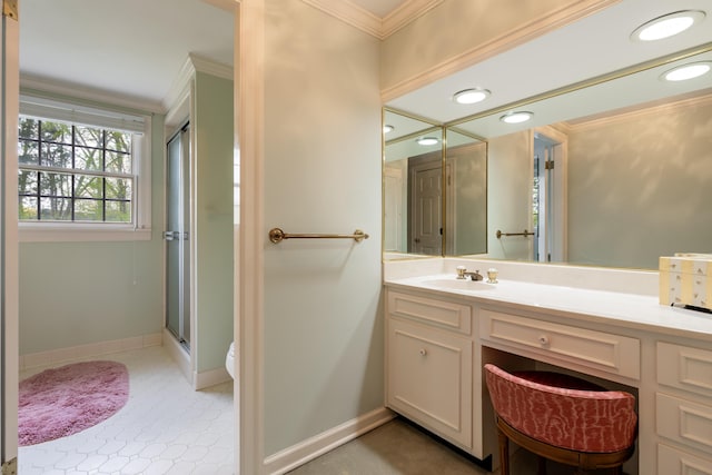 full bath featuring a shower stall, vanity, ornamental molding, toilet, and baseboards