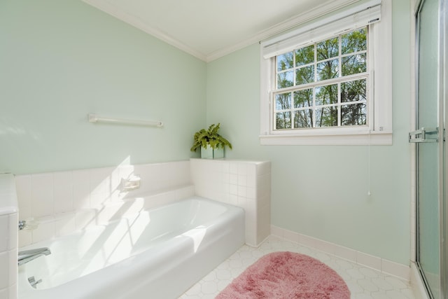 bathroom featuring a shower with door, baseboards, a garden tub, and ornamental molding