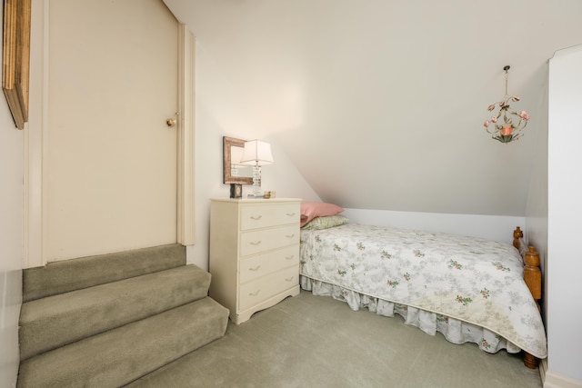 carpeted bedroom with lofted ceiling