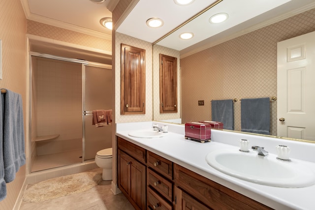 bathroom featuring toilet, a stall shower, a sink, and ornamental molding