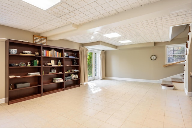 interior space with baseboards, stairway, and plenty of natural light