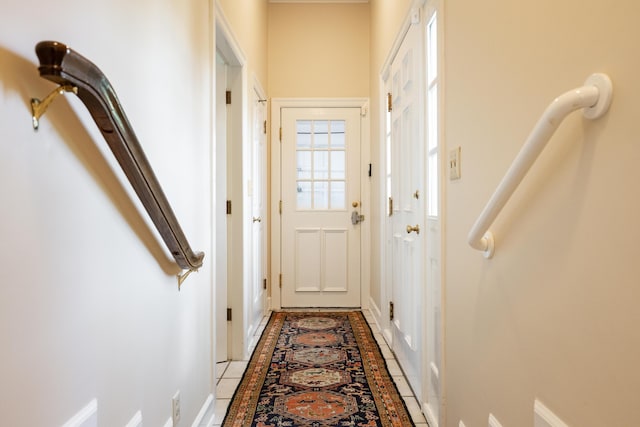 doorway featuring baseboards
