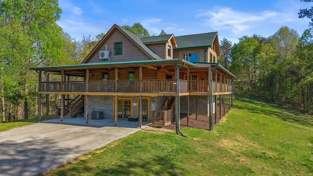 rear view of house with central air condition unit, a lawn, a patio area, driveway, and a deck