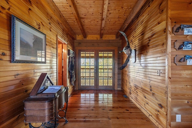 doorway to outside featuring beamed ceiling, wood ceiling, french doors, wooden walls, and wood-type flooring