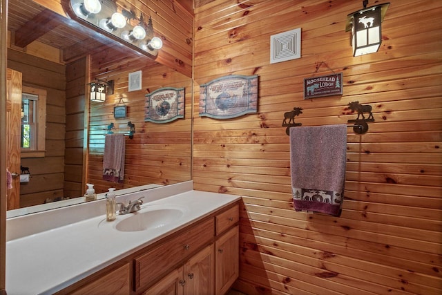 bathroom with wooden walls and vanity