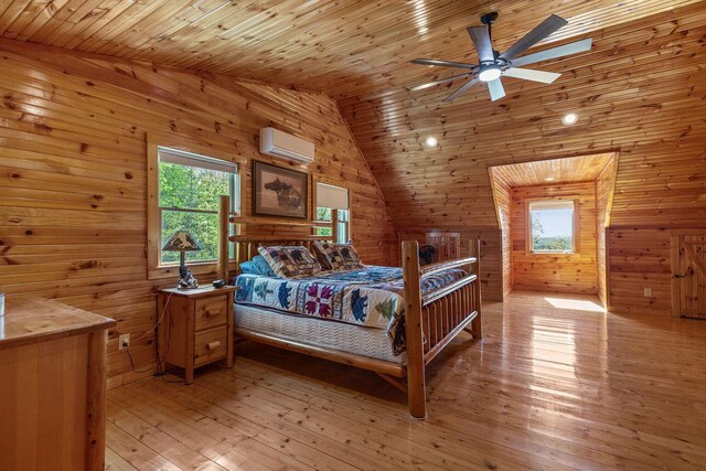 bedroom featuring a wall unit AC, wood walls, multiple windows, and lofted ceiling