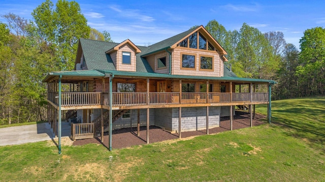 back of house featuring a yard, log exterior, and a deck