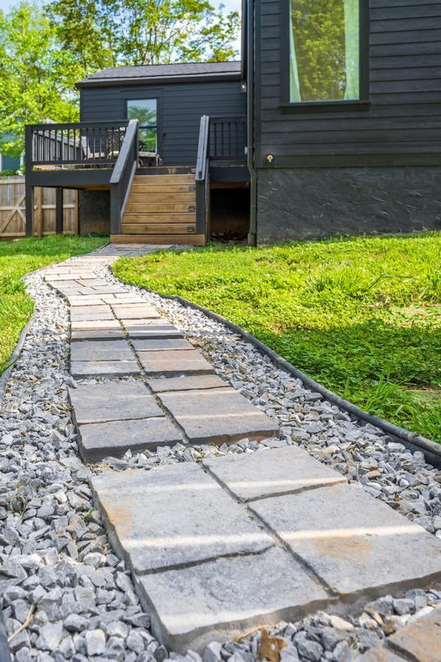 view of yard with stairway, a deck, and fence