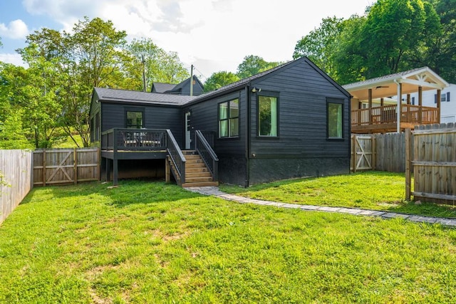 back of property featuring a wooden deck, stairway, a fenced backyard, a gate, and a yard