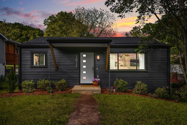 view of front of home with a yard