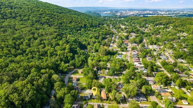birds eye view of property featuring a view of trees