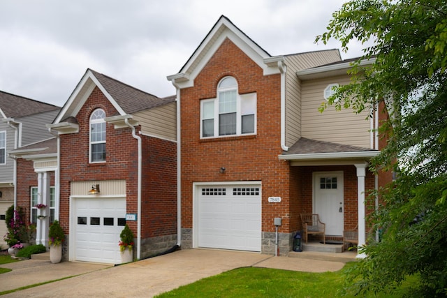 7845 Legacy Park Ct, Chattanooga, TN 37421 - view of front of home with concrete driveway, a garage, brick siding, and roof with shingles