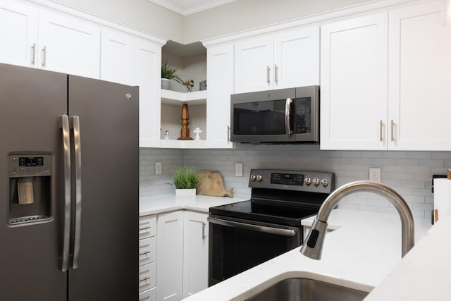 7845 Legacy Park Ct, Chattanooga, TN 37421 - kitchen with appliances with stainless steel finishes, open shelves, white cabinets, tasteful backsplash, and ornamental molding
