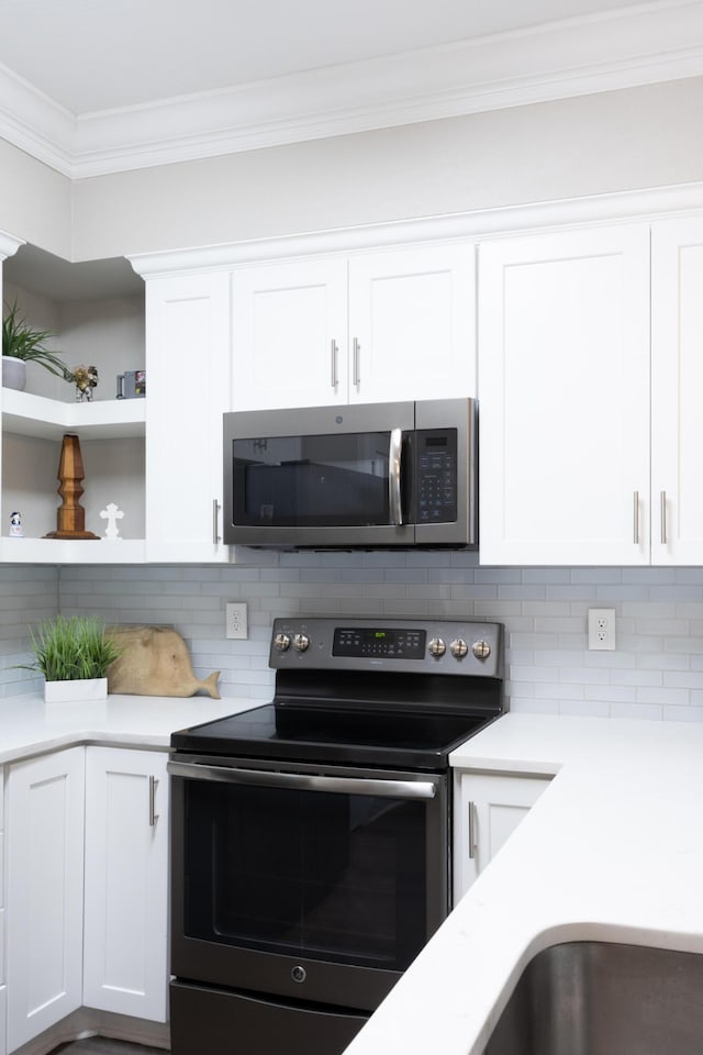 7845 Legacy Park Ct, Chattanooga, TN 37421 - kitchen featuring appliances with stainless steel finishes, crown molding, decorative backsplash, light countertops, and white cabinets