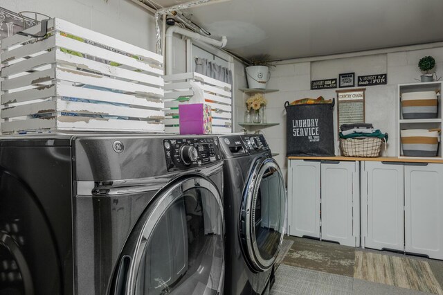 3745 Premium Dr, Chattanooga, TN 37415 - laundry area with washing machine and dryer, cabinet space, and concrete block wall