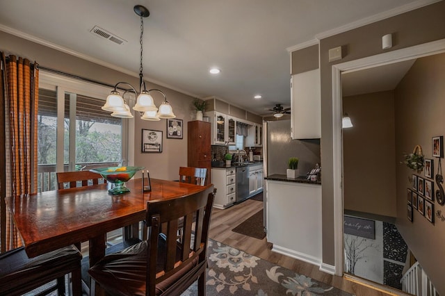 3745 Premium Dr, Chattanooga, TN 37415 - dining area featuring recessed lighting, wood finished floors, visible vents, crown molding, and ceiling fan