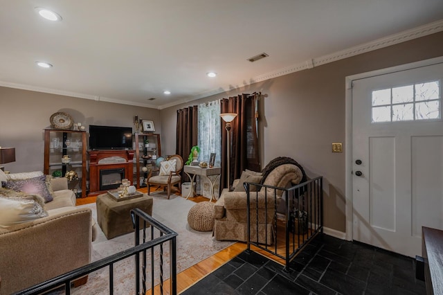 3745 Premium Dr, Chattanooga, TN 37415 - living area with recessed lighting, a glass covered fireplace, visible vents, and crown molding