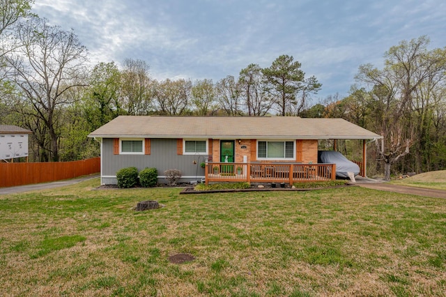 3745 Premium Dr, Chattanooga, TN 37415 - ranch-style home with a front lawn, driveway, a carport, a deck, and fence