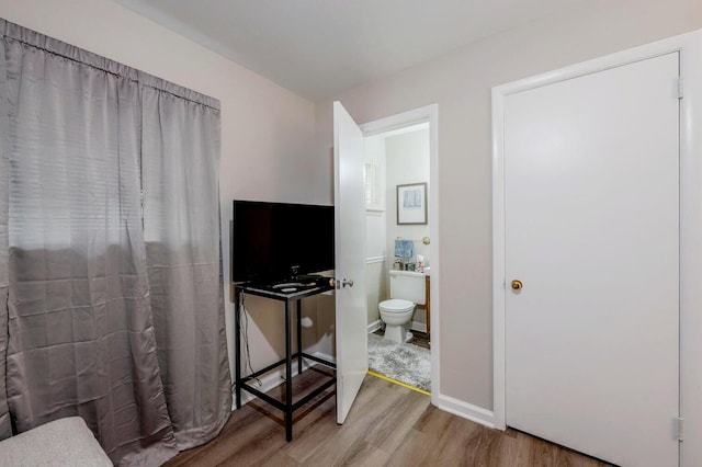 3745 Premium Dr, Chattanooga, TN 37415 - bedroom featuring connected bathroom and wood finished floors