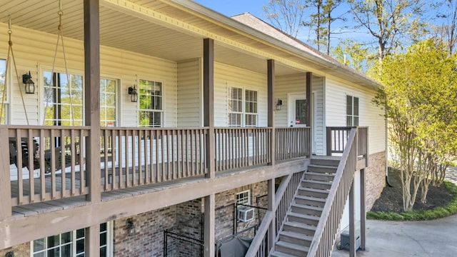 wooden terrace featuring stairs and a porch