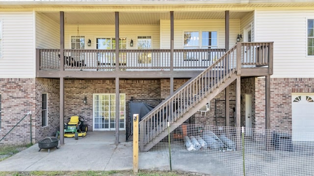 exterior space with a patio area, brick siding, and covered porch