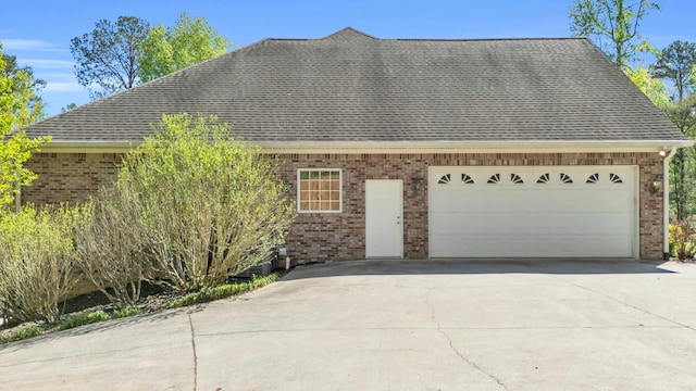 view of front facade featuring brick siding, an attached garage, and a shingled roof